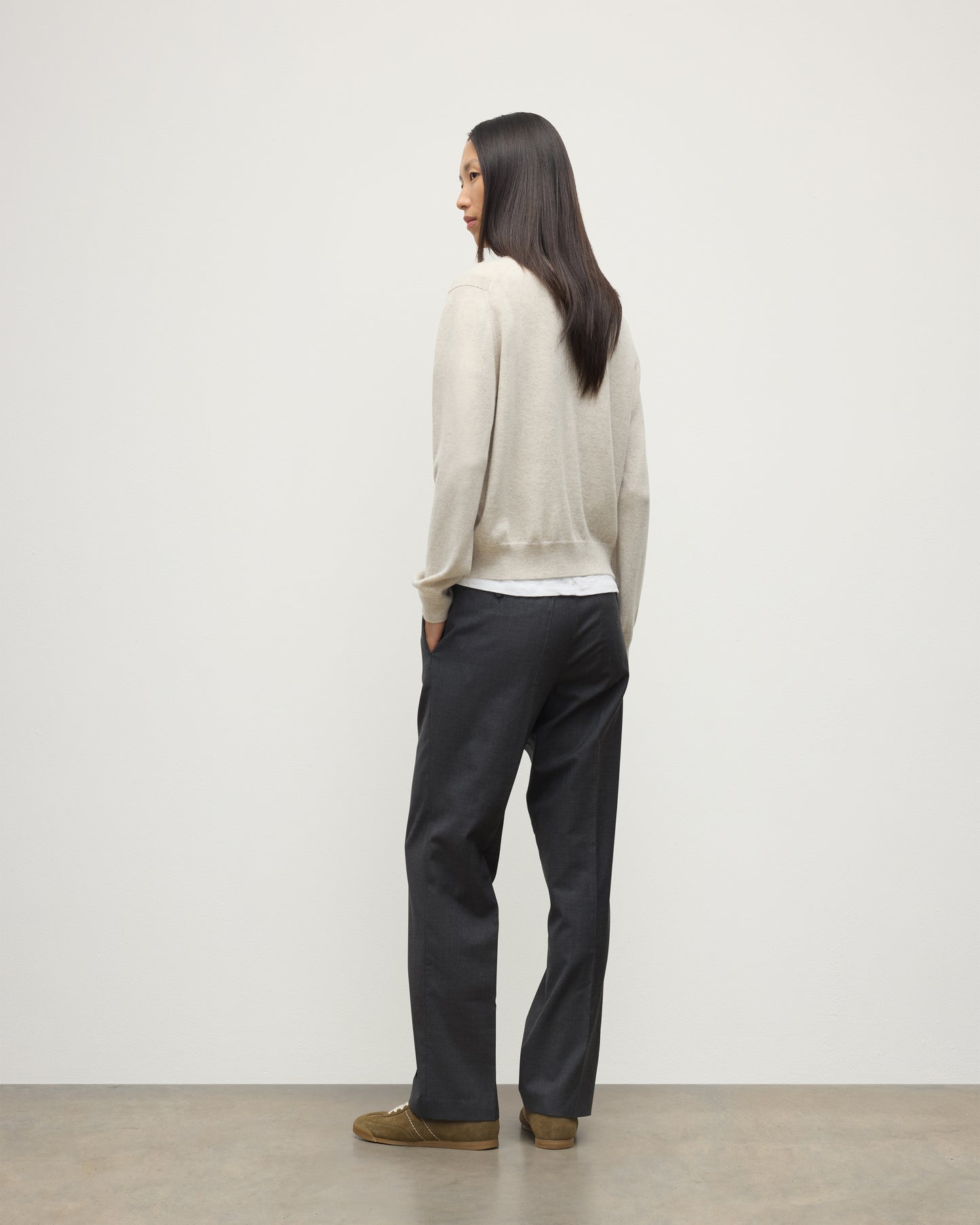 MODEL WEARING JOHNSTONS OF ELGIN WOMENS LUNAN CLASSIC VEE SWEATER NATURAL 100% CASHMERE WITH NAVY TROUSERS KAP05807HA0402