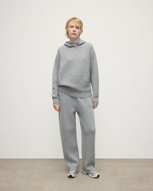 Model wears  Johnstons of Elgin AW25 Women's Knitwear Light Grey & White Double-Face Grey Cashmere Hoodie Front View KBA01034Q25324