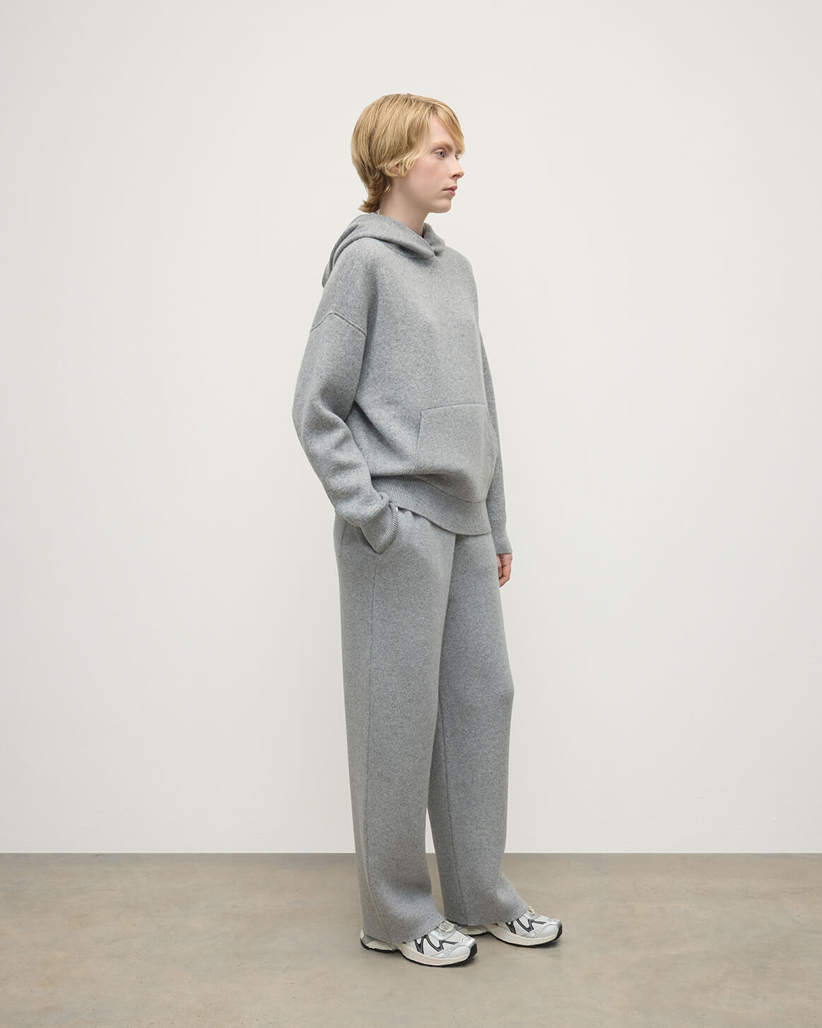 Model wears  Johnstons of Elgin AW25 Women's Knitwear Light Grey & White Double-Face Grey Cashmere Hoodie Side View KBA01034Q25324