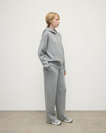 Model wears  Johnstons of Elgin AW25 Women's Knitwear Light Grey & White Double-Face Grey Cashmere Hoodie Side View KBA01034Q25324