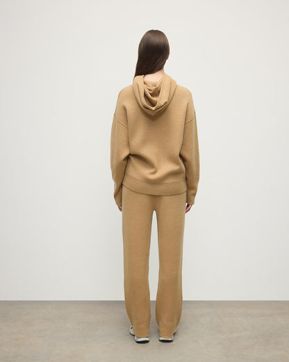 Model wears Johnstons of Elgin AW25 Women's Knitwear Camel & Natural Double-Face Camel Cashmere Hoodie Back View KBA01034Q25325