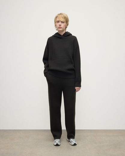 model wears Johnstons of Elgin AW25 Women's Knitwear Iron & Black Double-Face Black Cashmere Hoodie Front View KBA01034Q25336