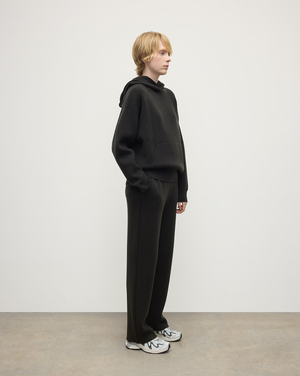 model wears Johnstons of Elgin AW25 Women's Knitwear Iron & Black Double-Face Black Cashmere Hoodie Side View KBA01034Q25336