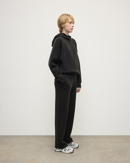 model wears Johnstons of Elgin AW25 Women's Knitwear Iron & Black Double-Face Black Cashmere Hoodie Side View KBA01034Q25336