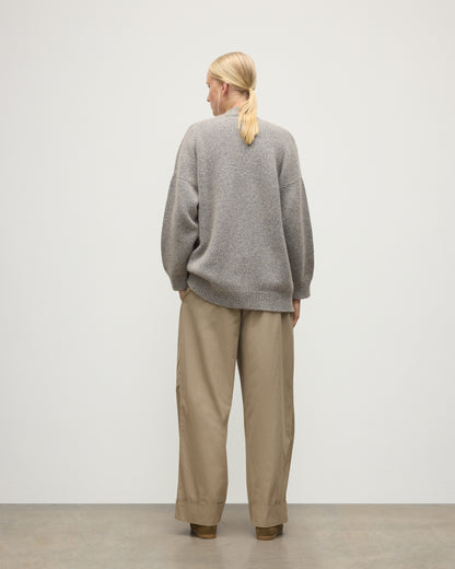 MODEL WEARS JOHNSTONS OF ELGIN WOMENS BAY SLOUCH CARDIGAN BLUE 78% CASHMERE 22% COTTON OVER A WHITE T-SHIRT WITH BROWN TROUSERS KBB01069HD4499