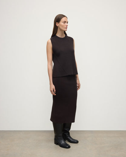 Model wears Johnstons of Elgin AW25 Women's Knitwear Molasses Cashmere Brown Midi Skirt KBC01032SB7290