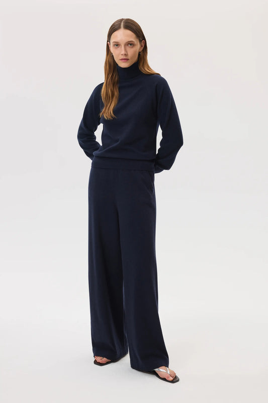 Johnstons of Elgin SS25 Women's Knitwear Navy High Rise Cashmere Culottes worn with navy cashmere roll neck and silver sandals KBP00926SD7286
