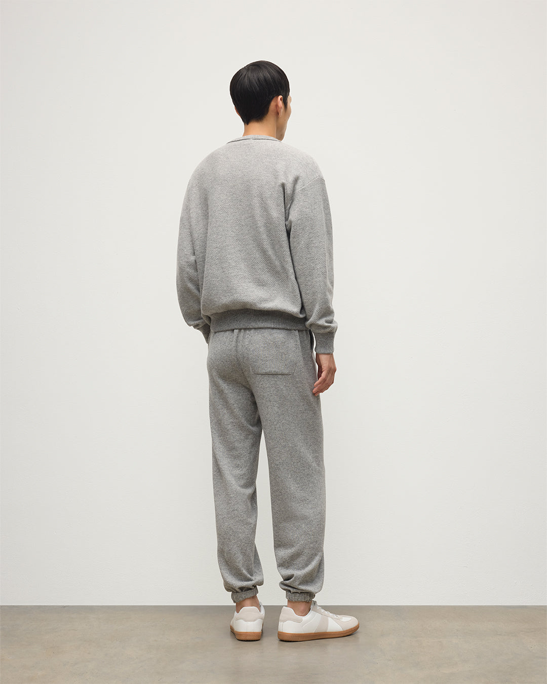MALE MODEL WEARS JOHNSTONS OF ELGIN MENS KIRK SWEATPANTS LIGHT GREY 97% CASHMERE 3% POLYESTER WITH LIDDEL CASHMERE SWEATSHIRT KBP00948HA0308