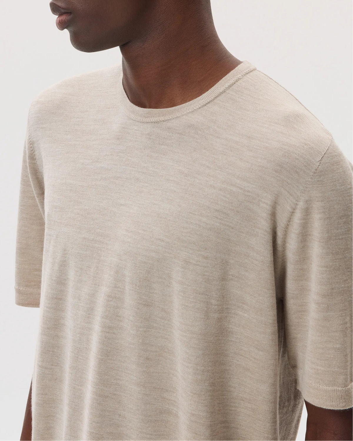 Model wears Johnstons of Elgin SS25 Men's Knitwear Natural Superfine Merino T-Shirt  KDI00663SB0695