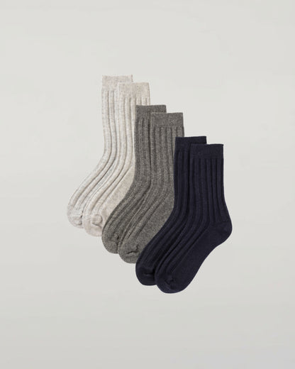 Johnstons of Elgin set of three pairs of cashmere socks in navy, light grey, and mid grey on a light grey background 2025GIFTSET4A
