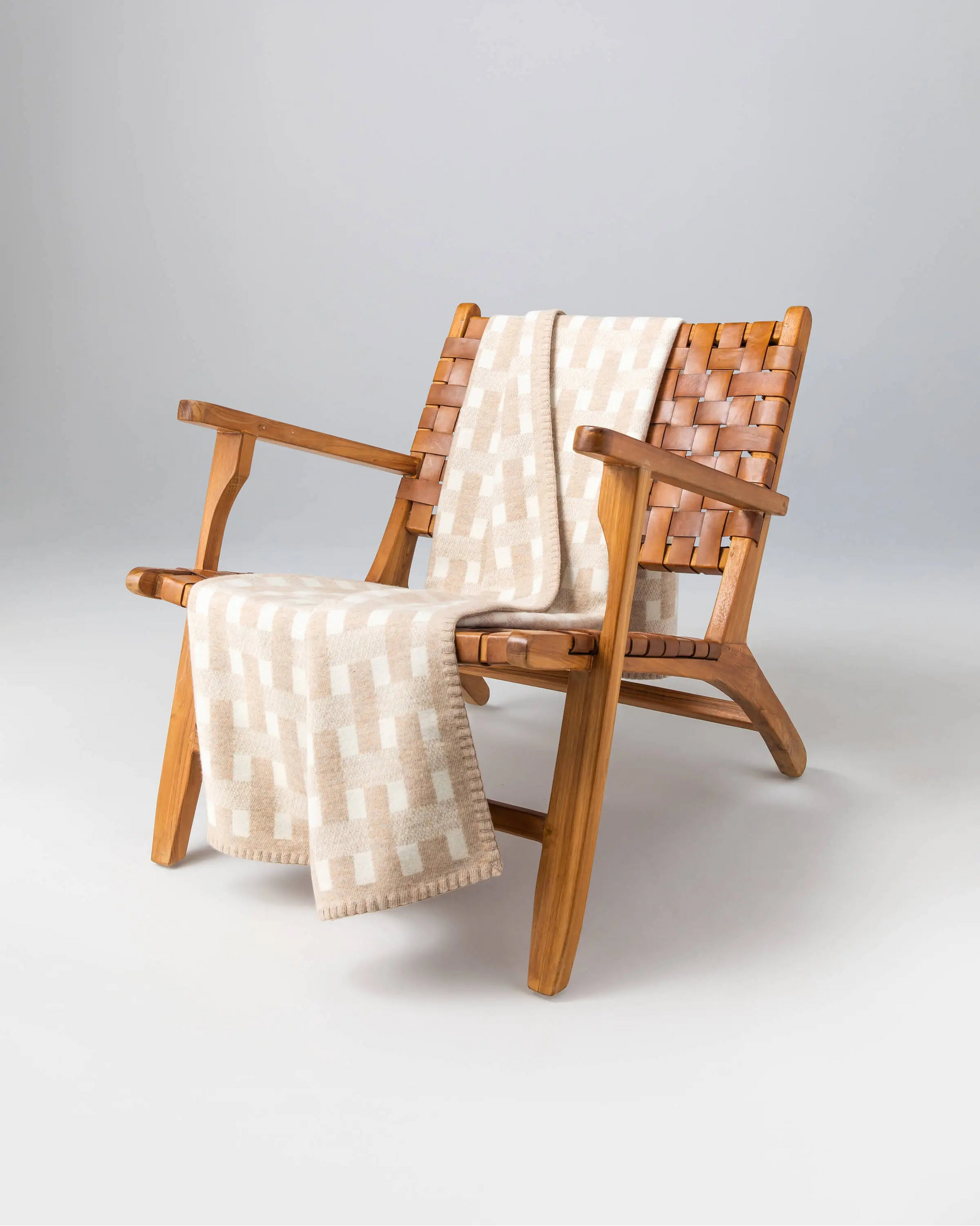 2025 Johnstons of Elgin Interiors Collection Oatmeal & White Blanket Stitched Basketweave Throw on a wooden chair  TB000500RU7443ONE