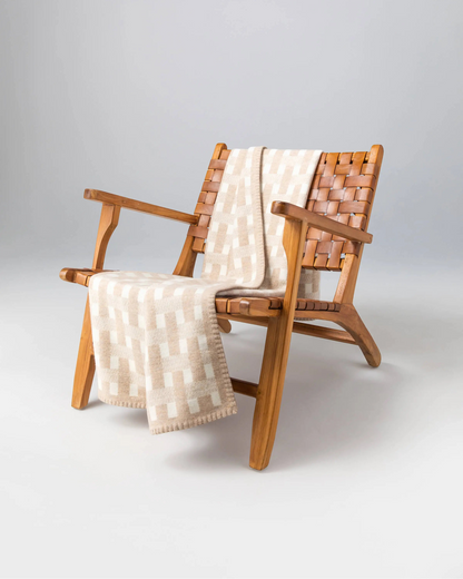 2025 Johnstons of Elgin Interiors Collection Oatmeal & White Blanket Stitched Basketweave Throw on a wooden chair  TB000500RU7443ONE