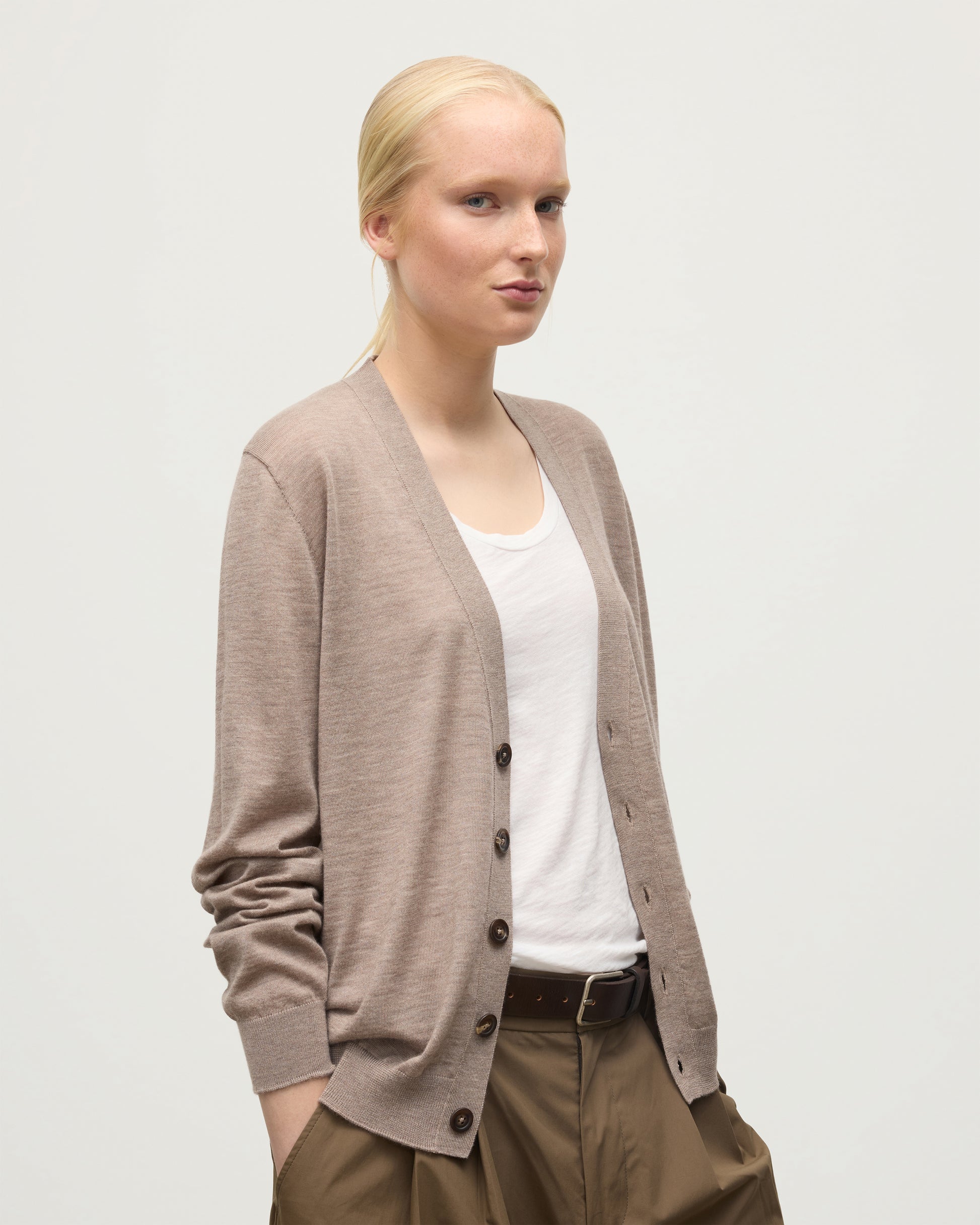FEMALE MODEL WEARING JOHNSTONS OF ELGIN FORSYTH SUPERFINE VEE NECK CARDIGAN LIGHT BROWN UAI05740HB0273