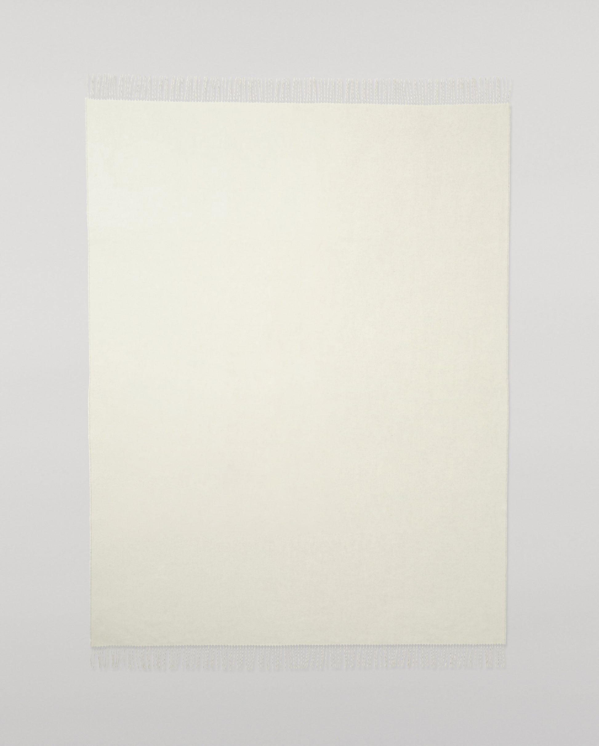 Johnstons of Elgin Light Grey & White reversible blanket on a grey background WA000013RU5059ONE