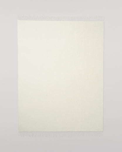 Johnstons of Elgin Light Grey & White reversible blanket on a grey background WA000013RU5059ONE
