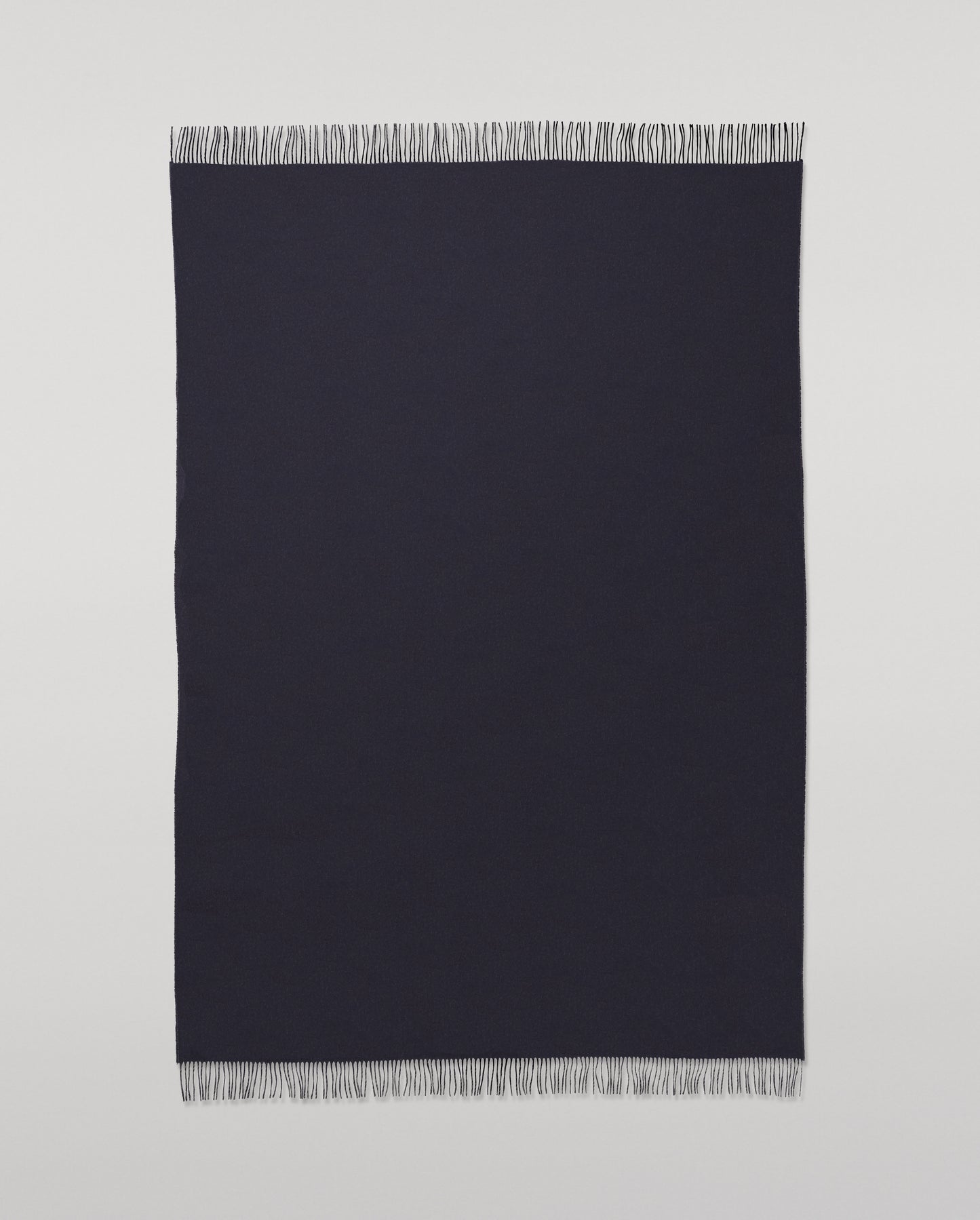 Johnstons of Elgin Interiors Collection  Reversible Navy & Light Grey Cashmere Throw on a wooden chair  WA000013RU6632N/A