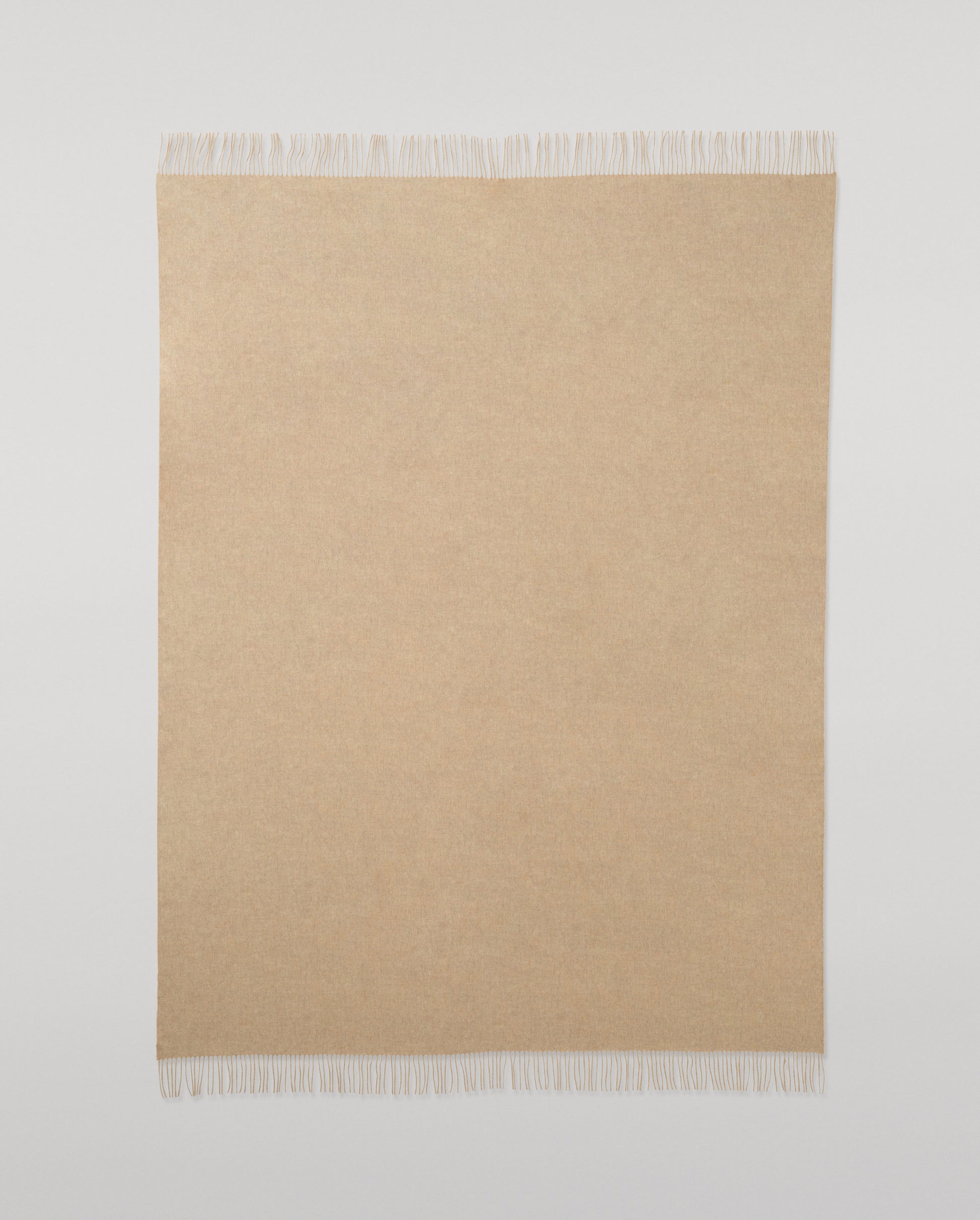 Johnstons of Elgin Interiors Collection Oatmeal Cashmere Throw on a wooden chair WA000055HB0210ONE