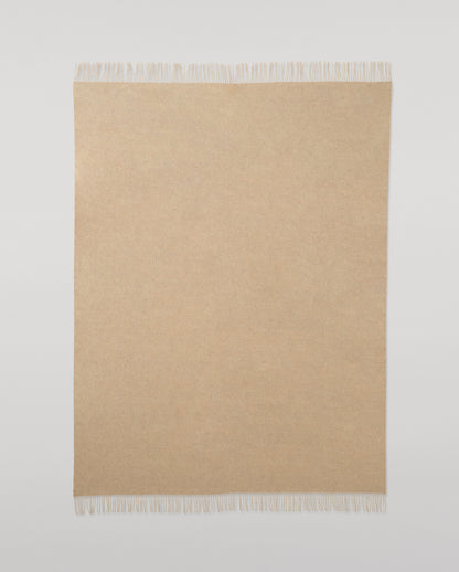 Johnstons of Elgin Interiors Collection Oatmeal Cashmere Throw on a wooden chair WA000055HB0210ONE
