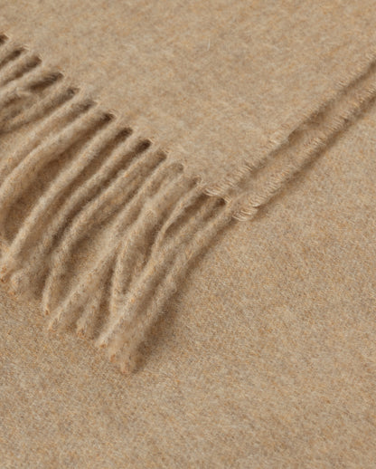 Johnstons of Elgin Interiors Collection Oatmeal Cashmere Throw on a wooden chair WA000055HB0210ONE