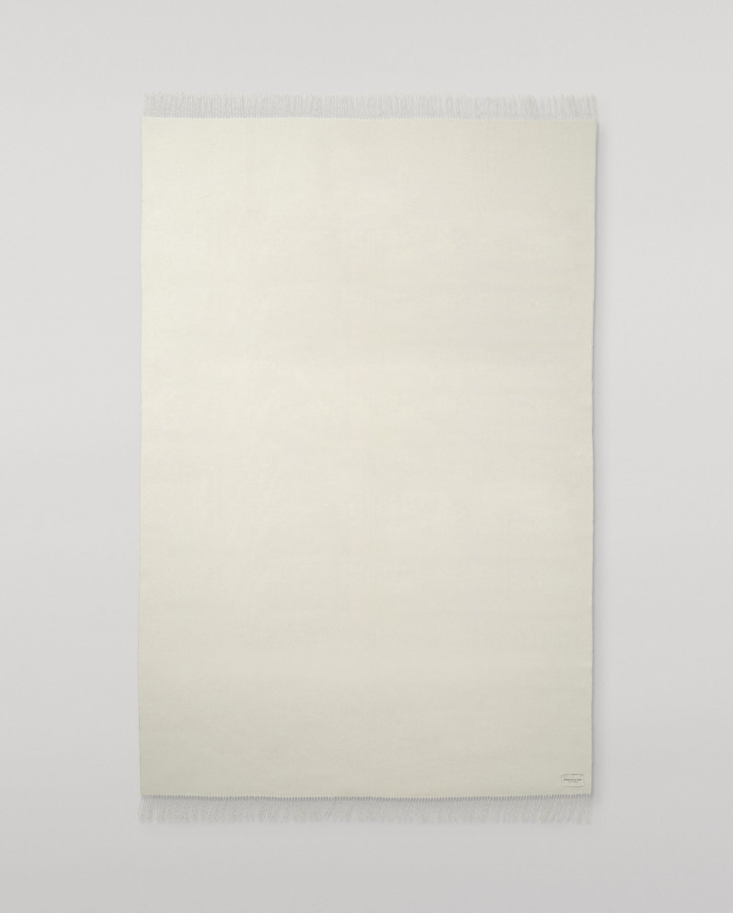 Johnstons of Elgin Interiors Collection White Cashmere Throw on grey background WA000055SA0000ONE