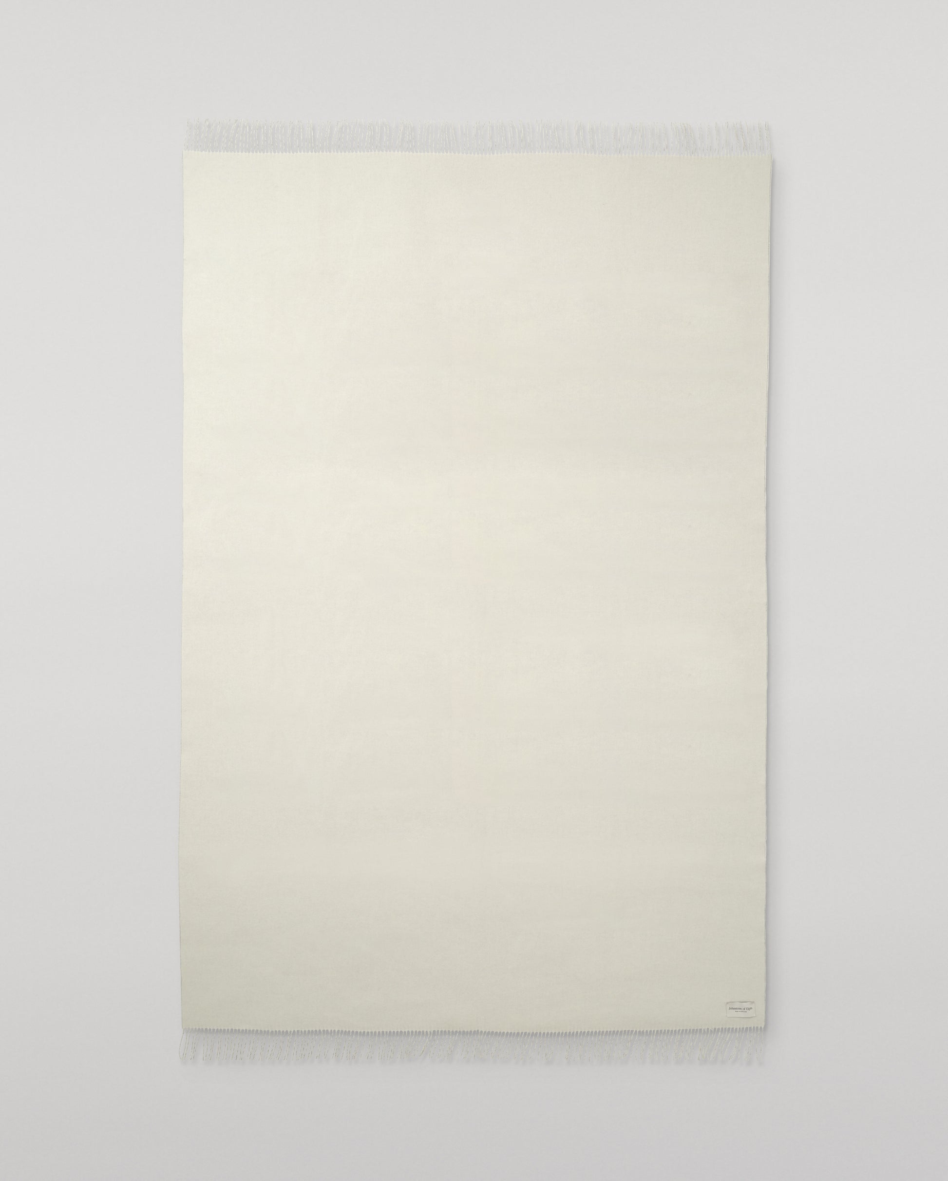 Johnstons of Elgin Interiors Collection White Cashmere Throw on grey background WA000055SA0000ONE
