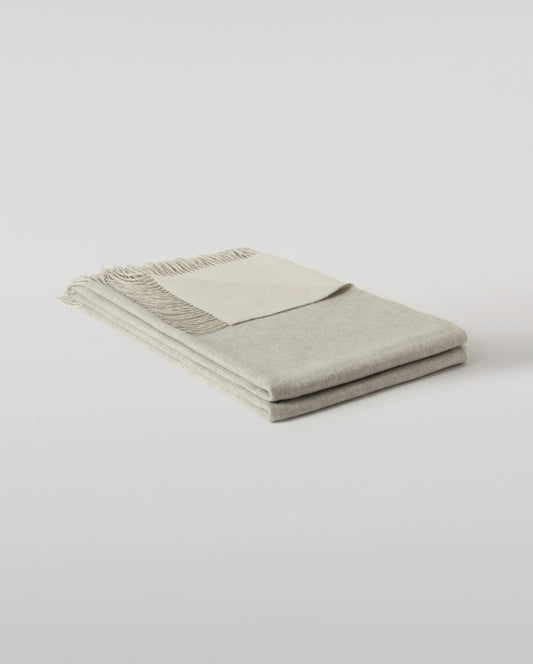 Johnstons of Elgin Interiors Collection Silver & White Reversible Cashmere Bed Throw on a white background  WA001374RU6322ONE