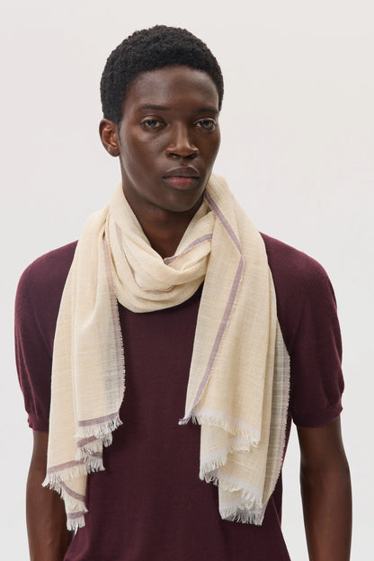 Male model wearing Johnstons of Elgin SS25 Accessories Natural Colour Border Lightweight Scarf over our rosewood superfine cashmere t-shirt, on a white background WB002693RU7595ONE