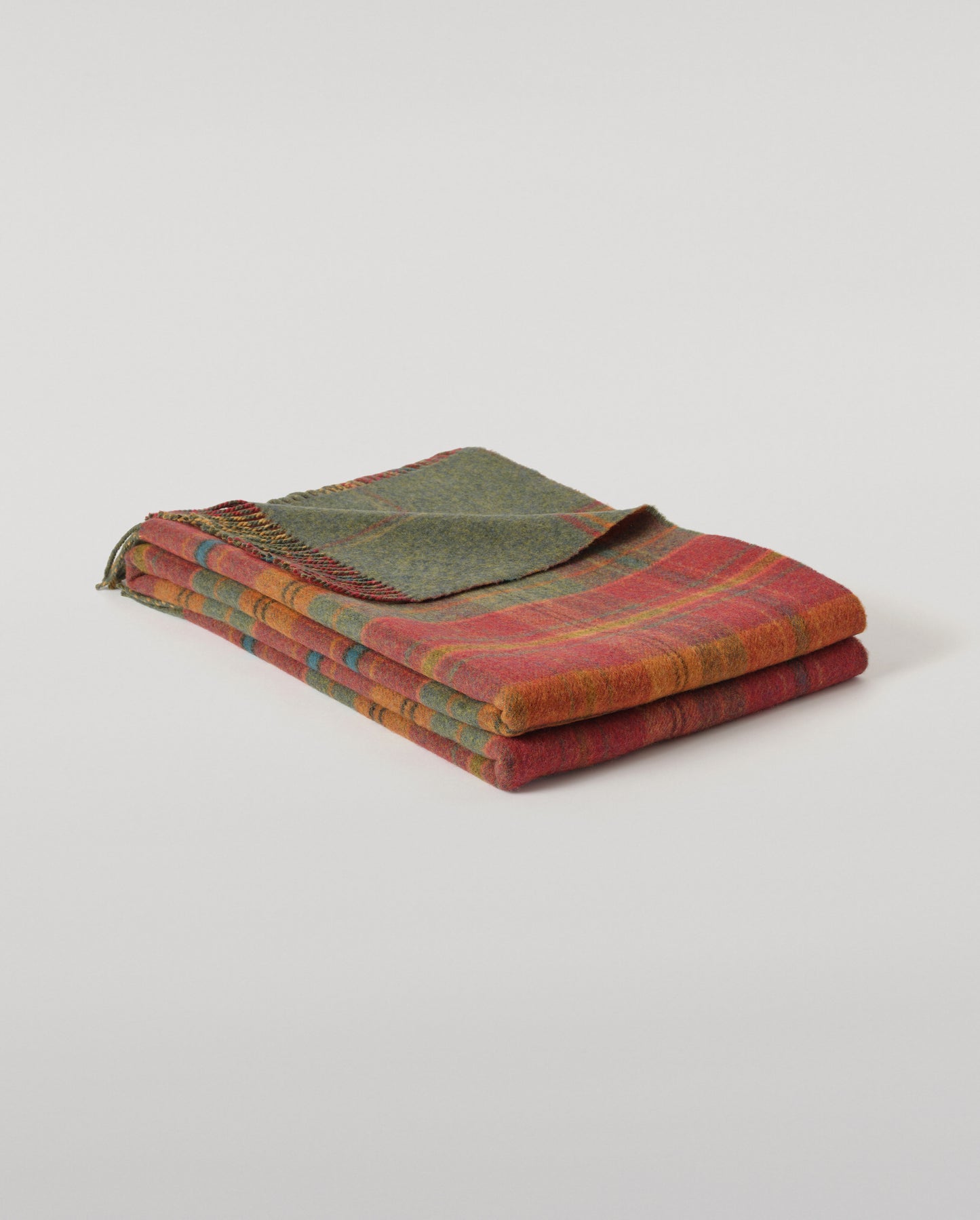 Johnstons of Elgin Interiors Collection Red Tweed & Green Windowpane Reversible Lambswool Throw on a grey background  WD000021XU0036N/A