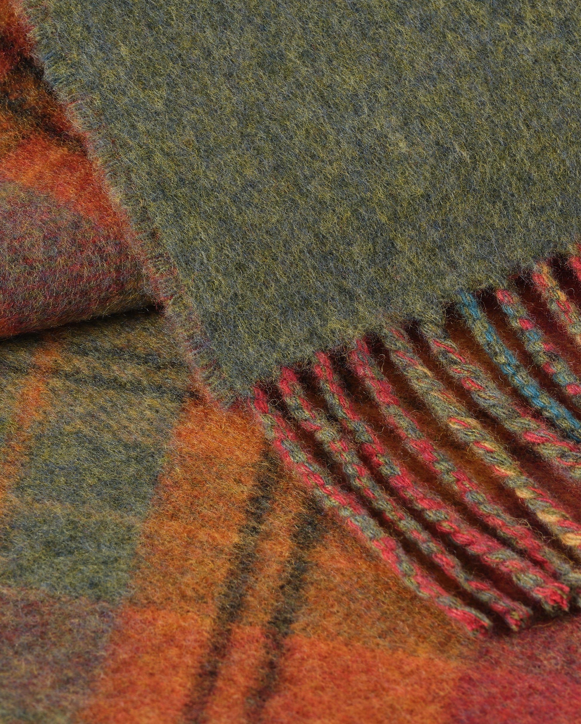 Johnstons of Elgin Interiors Collection Red Tweed & Green Windowpane Reversible Lambswool Throw on a grey background  WD000021XU0036N/A