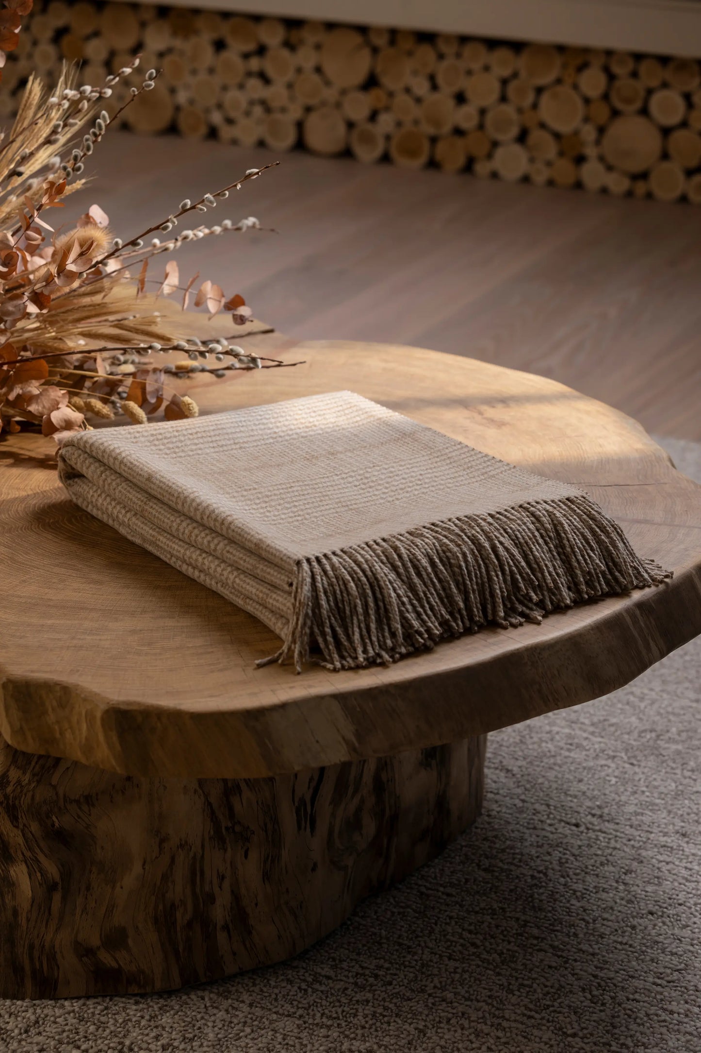 2025 Johnstons of Elgin Interiors Collection Natural Tweed Glen Check Wool Throw folded on a wooden table   WDC01930RU7651ONE