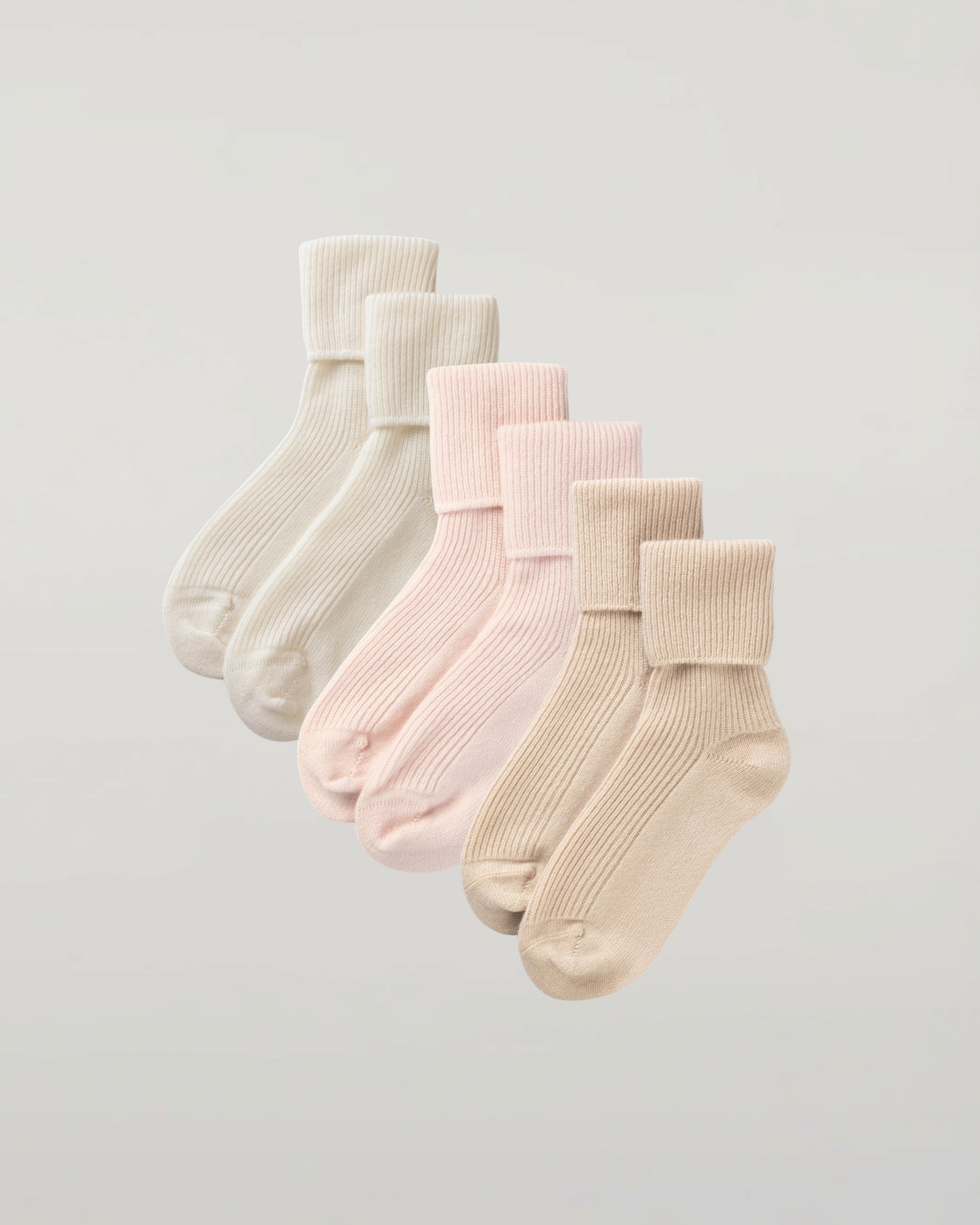 Johnstons of Elgin set of three pairs of cashmere socks in pastel colours on a light grey background 2025GIFTSET3A